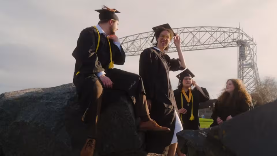 UMD graduates gather by Aerial Lift Bridge in Duluth